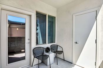 Two black chairs are placed on a patio.
